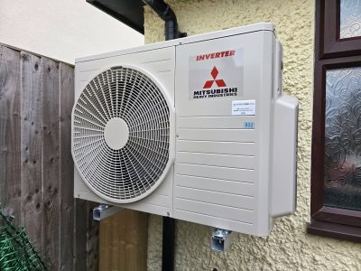 High-quality Mitsubishi HVAC inverter unit installed outside for reliable heating and cooling.